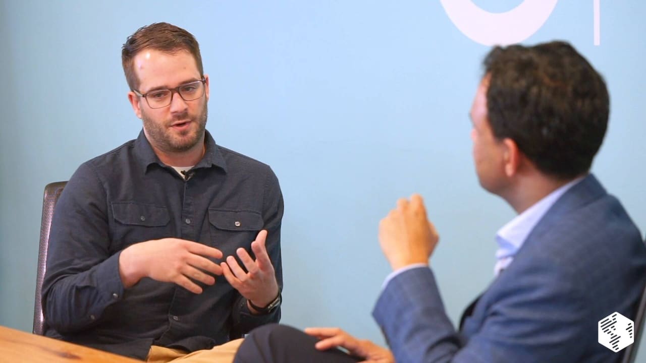 Two people in conversation on set, from Coffee With Closers with Jakub